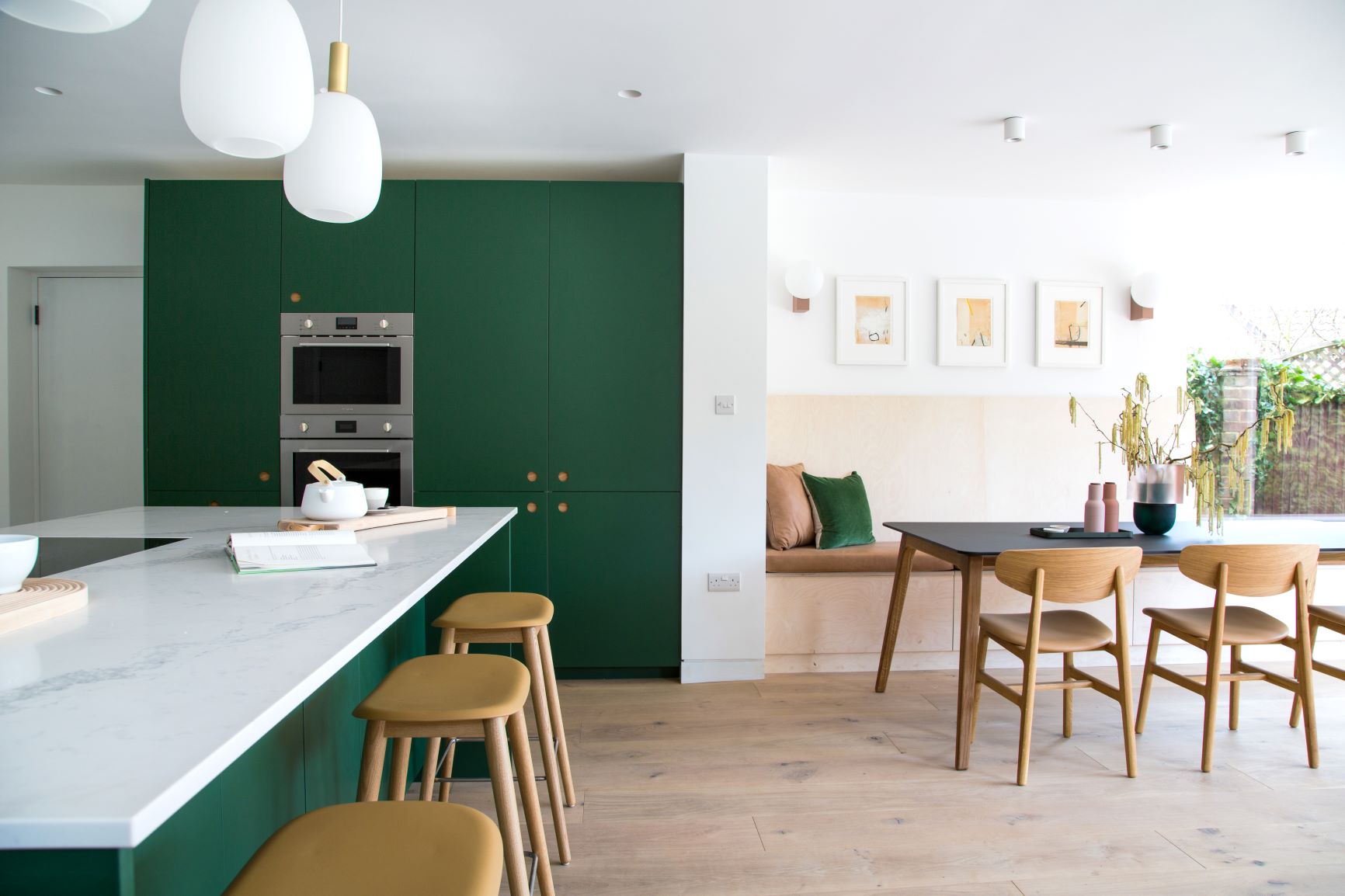 Dark green ladbroke handleless kitchen and table